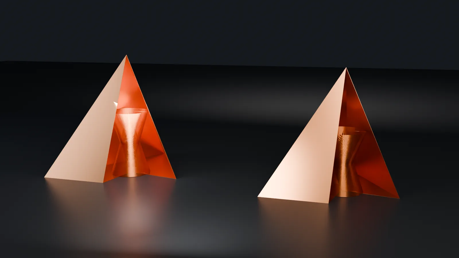 Two copper tetrahedra side by side, each cut open at the front to show a double-cone copper coil inside. Left: V1, golden ratio. Right: V2, square root of two.